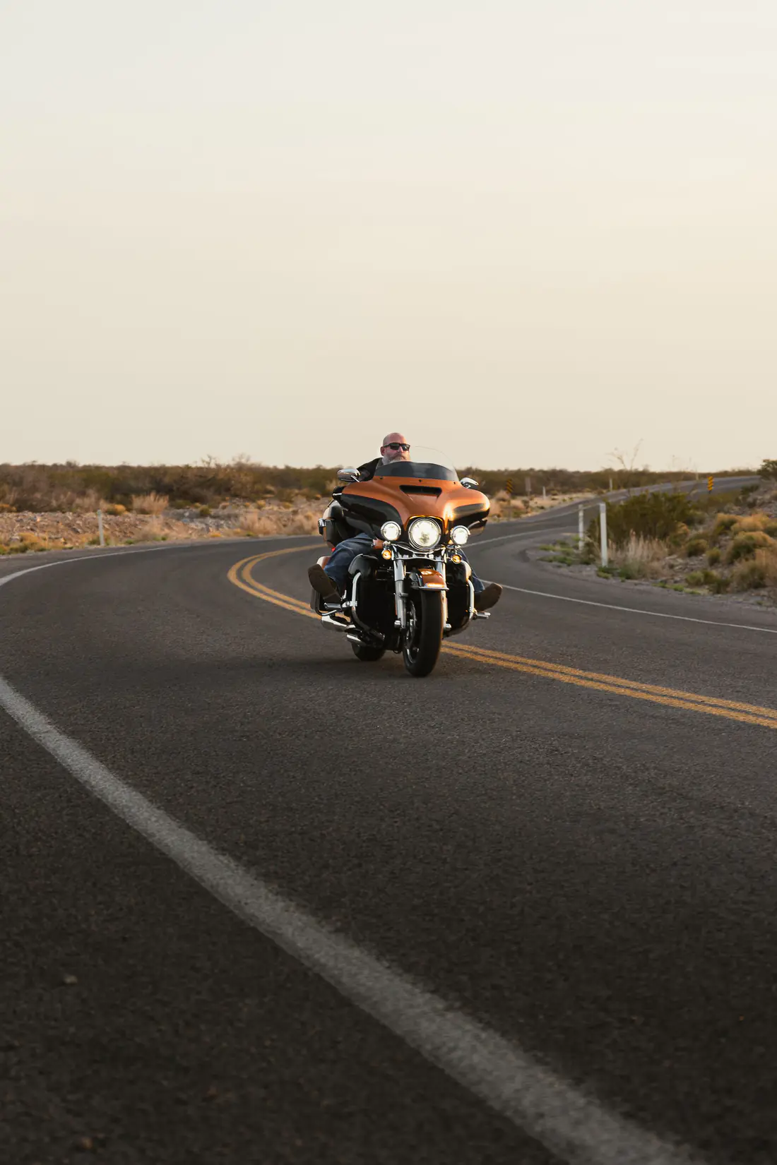 Illustrative stock photograph of a touring motorcycle rider on an open road