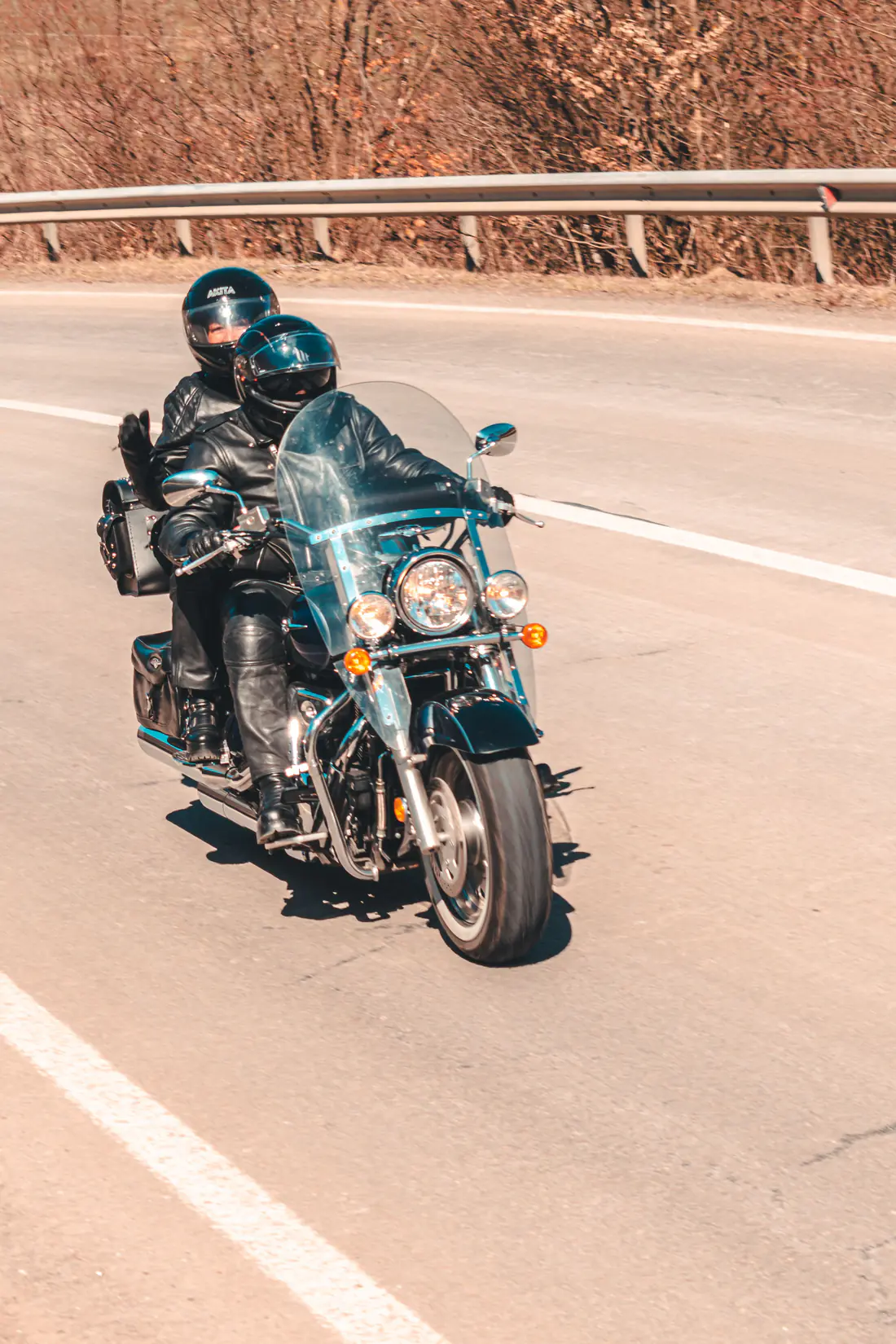 Illustrative stock photograph of a motorcycle rider on an open American road