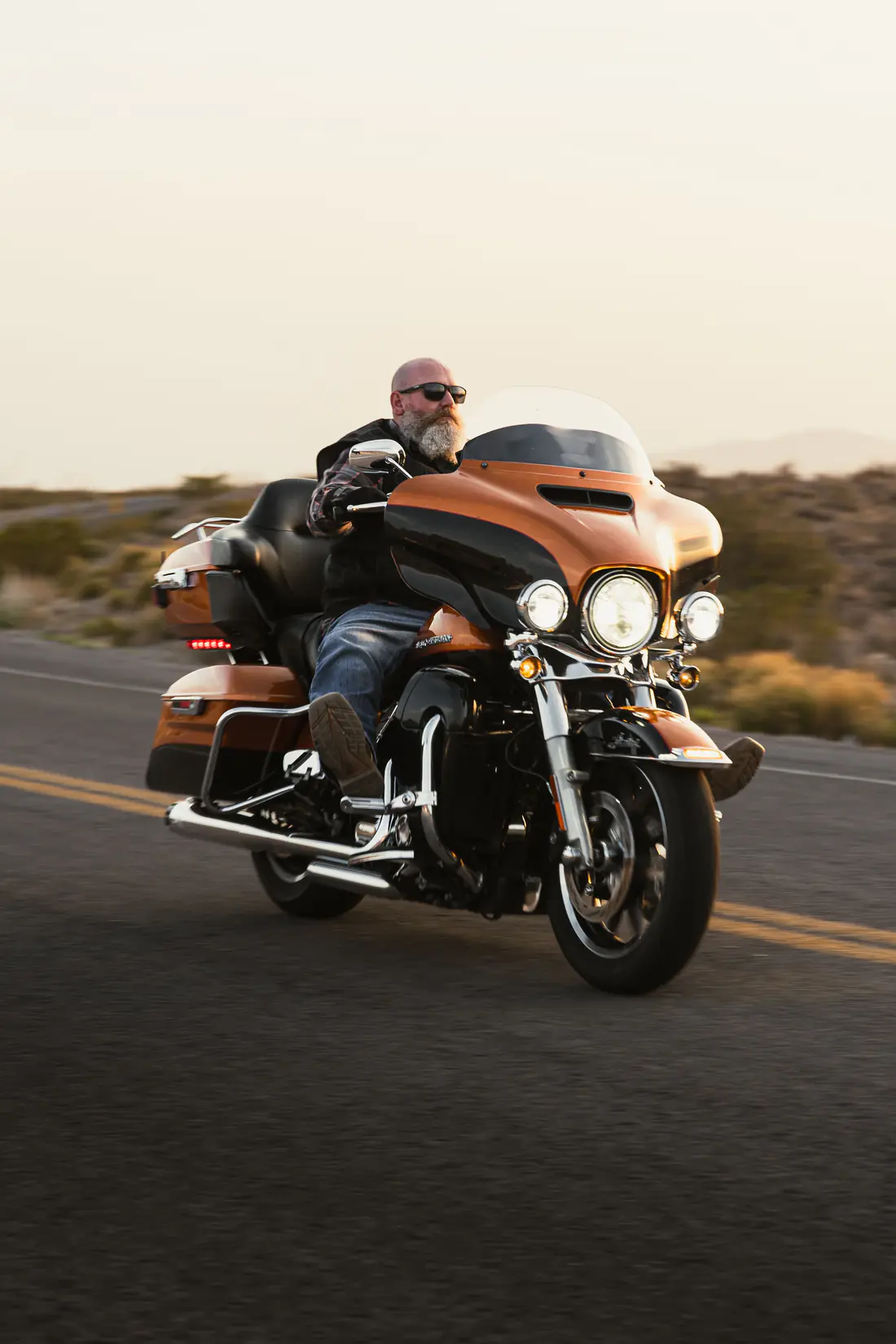 Illustrative stock photograph of a touring motorcycle rider approaching on a road